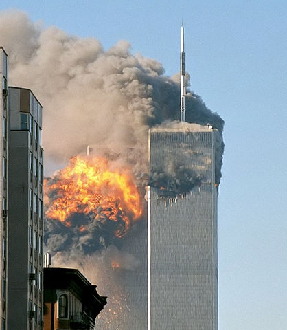 "North face south tower after plane strike 9-11" by Robert on Flickr - →This file has been extracted from another file: UA Flight 175 hits WTC south tower 9-11 edit.jpeg.. Licensed under CC BY-SA 2.0 via Commons - https://commons.wikimedia.org/wiki/File:North_face_south_tower_after_plane_strike_9-11.jpg#/media/File:North_face_south_tower_after_plane_strike_9-11.jpg